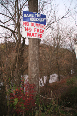 A sign by the Save the Nolichucky organization fighting the plan to draw and discharge water into the river that runs between Greene and Cocke counties.